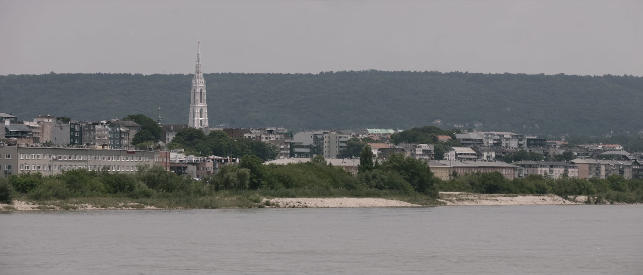 Der Strom, ein gotischer Turm über der niedrigen Stadt, ein Höhenzug dahinter
